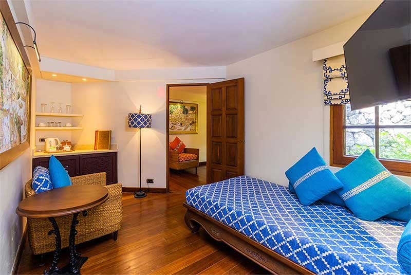 full image of a large bed in a cottage with blue decor at Anavana Beach Resort